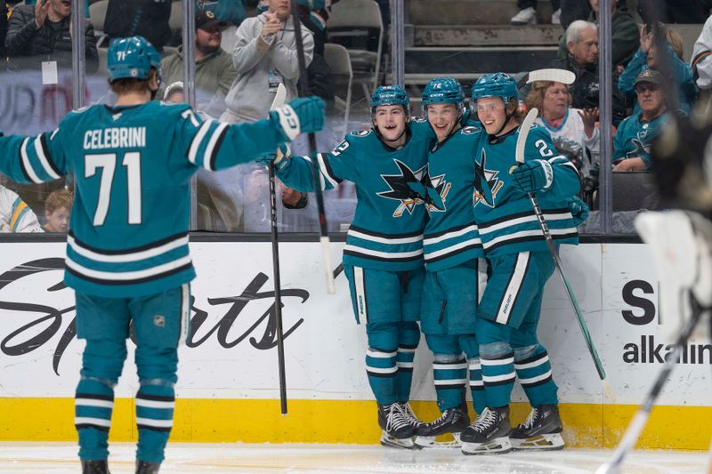 Mar 22, 2025; San Jose, California, USA;  San Jose Sharks defenseman Luca Cagnoni (42), left wing William Eklund (72) and center Will Smith (2) wait for teammate center Macklin Celebrini (71) to celebrate during the second period against the Boston Bruins at SAP Center at San Jose. Mandatory Credit: Stan Szeto-Imagn Images