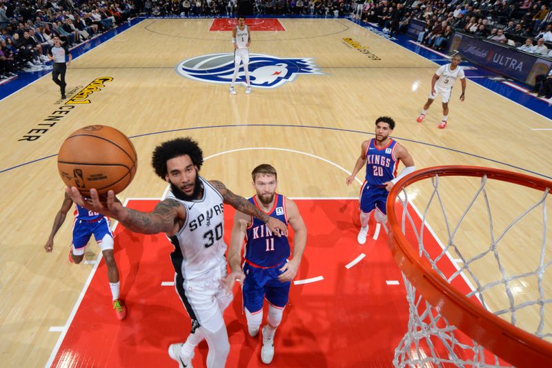 SACRAMENTO, CA - DECEMBER 1: Julian Champagnie #30 of the San Antonio Spurs drives to the basket during the game against the Sacramento Kings on December 1, 2024 at Golden 1 Center in Sacramento, California. NOTE TO USER: User expressly acknowledges and agrees that, by downloading and or using this Photograph, user is consenting to the terms and conditions of the Getty Images License Agreement. Mandatory Copyright Notice: Copyright 2024 NBAE (Photo by Rocky Widner/NBAE via Getty Images)