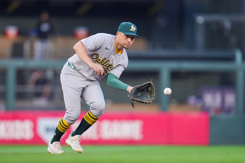 Jun 13, 2024; Minneapolis, Minnesota, USA; Oakland Athletics shortstop Aledmys Díaz (6) fields a ground ball against the Minnesota Twins in the seventh inning at Target Field. Mandatory Credit: Brad Rempel-USA TODAY Sports