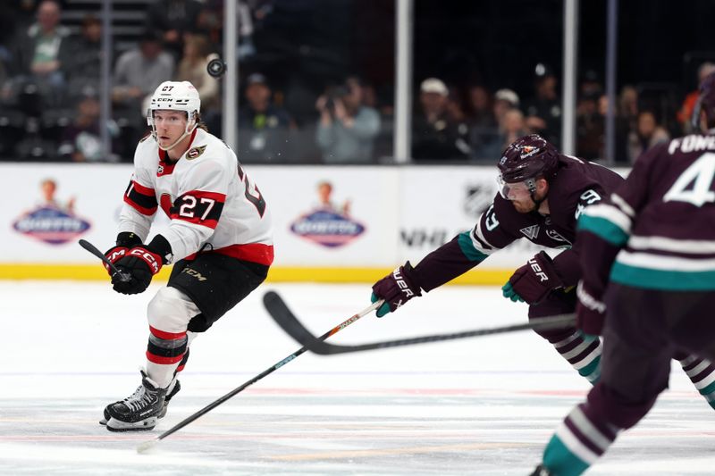 Mar 6, 2024; Anaheim, California, USA;  Ottawa Senators left wing Parker Kelly (27) passes the puck against Anaheim Ducks left wing Max Jones (49) during the third period at Honda Center. Mandatory Credit: Kiyoshi Mio-USA TODAY Sports