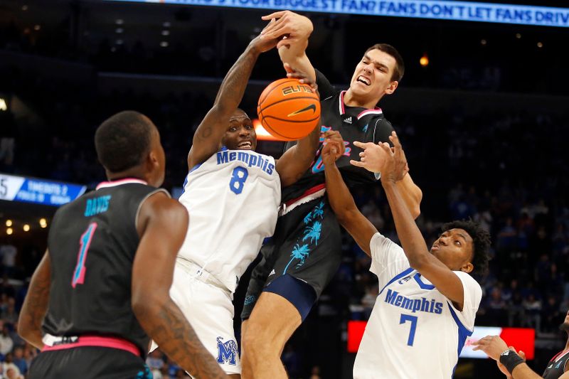 Feb 25, 2024; Memphis, Tennessee, USA; Memphis Tigers forward David Jones (8) and forward Nae'Qwan Tomlin (7) battle Florida Atlantic Owls center Vladislav Goldin (50) for a rebound during the second half at FedExForum. Mandatory Credit: Petre Thomas-USA TODAY Sports