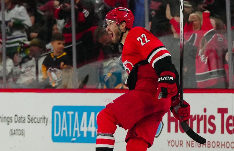 Jan 13, 2024; Raleigh, North Carolina, USA;  Carolina Hurricanes defenseman Brett Pesce (22) celebrates his game winning goal in the overtime against the Pittsburgh Penguins at PNC Arena. Mandatory Credit: James Guillory-USA TODAY Sports