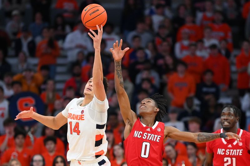 Feb 14, 2023; Syracuse, New York, USA; Syracuse Orange center Jesse Edwards (14) and North Carolina State Wolfpack guard Terquavion Smith (0) battle for the ball during the second half at the JMA Wireless Dome. Mandatory Credit: Rich Barnes-USA TODAY Sports