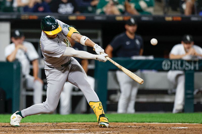 Sep 14, 2024; Chicago, Illinois, USA; Oakland Athletics shortstop Max Schuemann (12) doubles against the Chicago White Sox during the sixth inning at Guaranteed Rate Field. Mandatory Credit: Kamil Krzaczynski-Imagn Images
