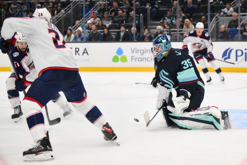 Nov 12, 2024; Seattle, Washington, USA; Seattle Kraken goaltender Joey Daccord (35) blocks a goal shot against the Columbus Blue Jackets during the second period at Climate Pledge Arena. Mandatory Credit: Steven Bisig-Imagn Images