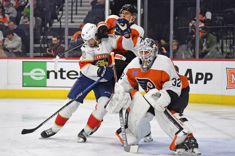 Mar 24, 2024; Philadelphia, Pennsylvania, USA; Philadelphia Flyers defenseman Erik Johnson (77) and Florida Panthers center Kevin Stenlund (82) battle for position near goaltender Felix Sandstrom (32) during the second period at Wells Fargo Center. Mandatory Credit: Eric Hartline-USA TODAY Sports