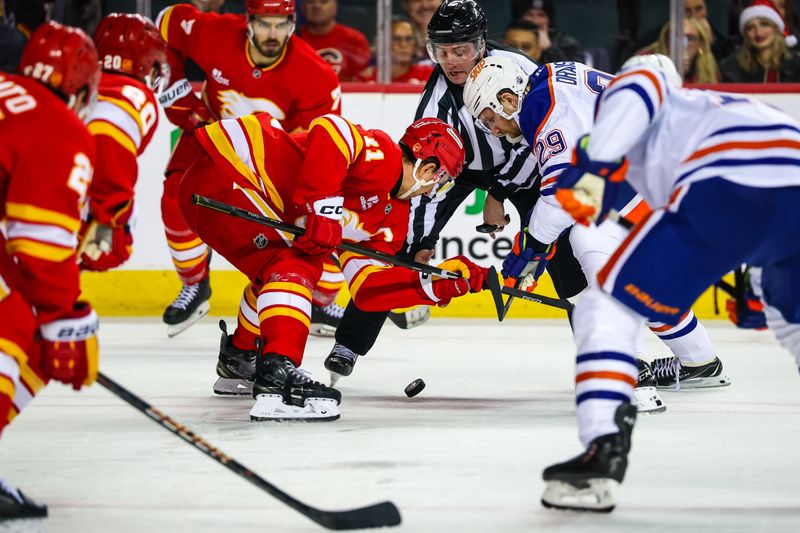 Dec 27, 2025; Calgary, Alberta, CAN; Calgary Flames center Mikael Backlund (11) and Edmonton Oilers center Leon Draisaitl (29) face off for the puck during the third period at Scotiabank Saddledome. Mandatory Credit: Sergei Belski-Imagn Images