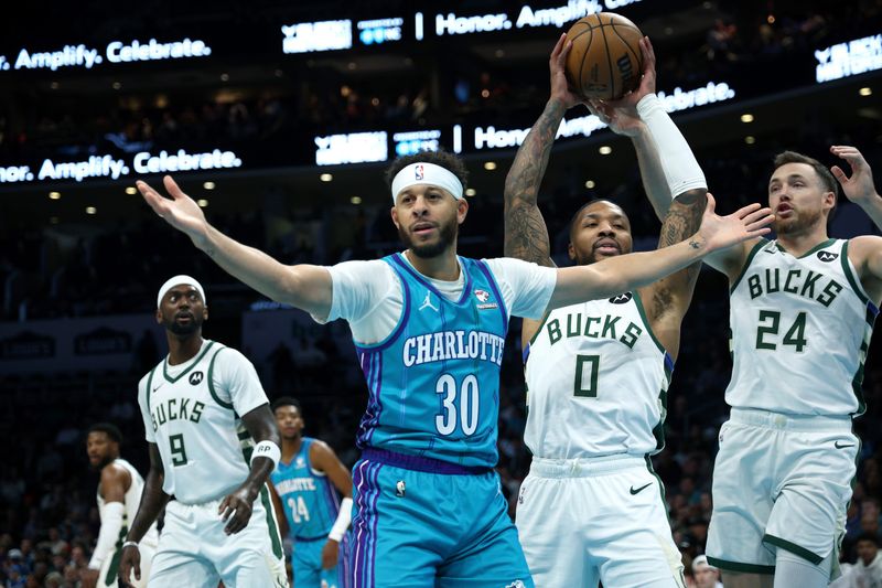 CHARLOTTE, NORTH CAROLINA - FEBRUARY 29: Seth Curry #30 of the Charlotte Hornets reacts following a lay up against Damian Lillard #0 of the Milwaukee Bucks during the first half of the game at Spectrum Center on February 29, 2024 in Charlotte, North Carolina. NOTE TO USER: User expressly acknowledges and agrees that, by downloading and or using this photograph, User is consenting to the terms and conditions of the Getty Images License Agreement. (Photo by Jared C. Tilton/Getty Images)