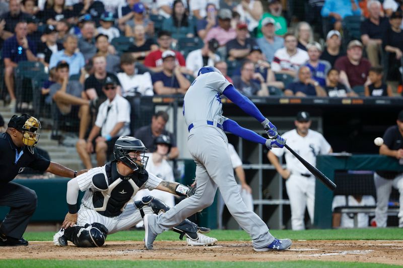 Jun 25, 2024; Chicago, Illinois, USA; Los Angeles Dodgers first baseman Freddie Freeman (5) hits a two-run home run against the Chicago White Sox during the third inning at Guaranteed Rate Field. Mandatory Credit: Kamil Krzaczynski-USA TODAY Sports