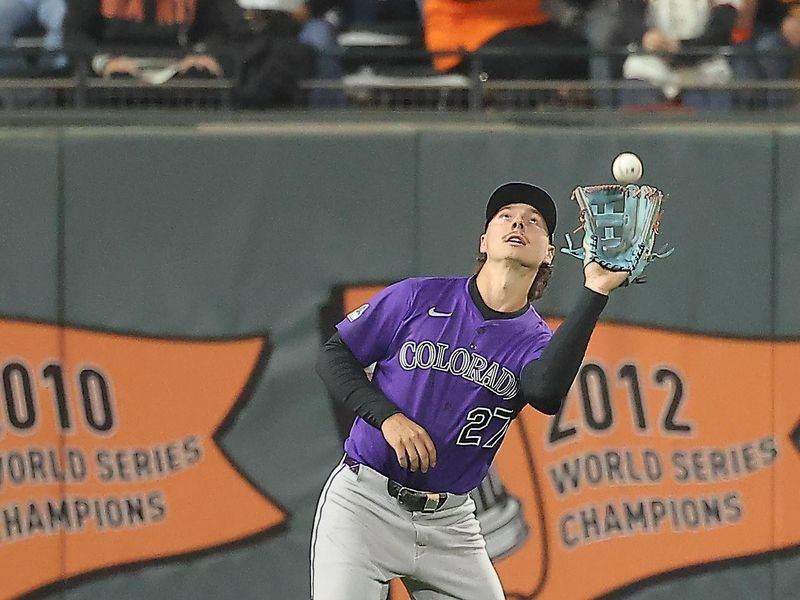 Sep 26, 2025; San Francisco, California, USA; Colorado Rockies left fielder Jordan Beck (27) catches the ball against the San Francisco Giants during the third inning at Oracle Park. Mandatory Credit: Kelley L Cox-Imagn Images