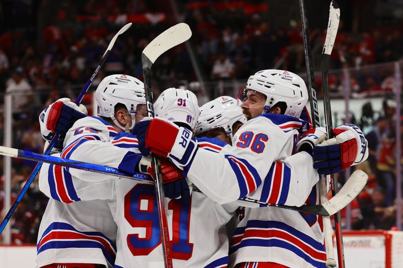 May 26, 2024; Sunrise, Florida, USA; New York Rangers center Alex Wennberg (91) celebrates with center Jack Roslovic (96) and right wing Kaapo Kakko (24) after scoring the game-winning goal in overtime against the Florida Panthers in game three of the Eastern Conference Final of the 2024 Stanley Cup Playoffs at Amerant Bank Arena. Mandatory Credit: Sam Navarro-USA TODAY Sports