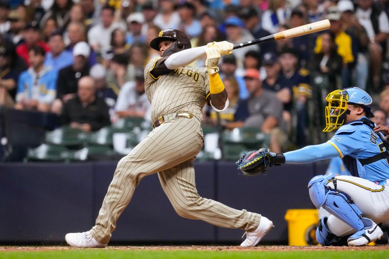 Jun 6, 2025; Milwaukee, Wisconsin, USA;  San Diego Padres catcher Martín Maldonado (15) hits a double during the seventh inning against the Milwaukee Brewers at American Family Field. Mandatory Credit: Jeff Hanisch-Imagn Images