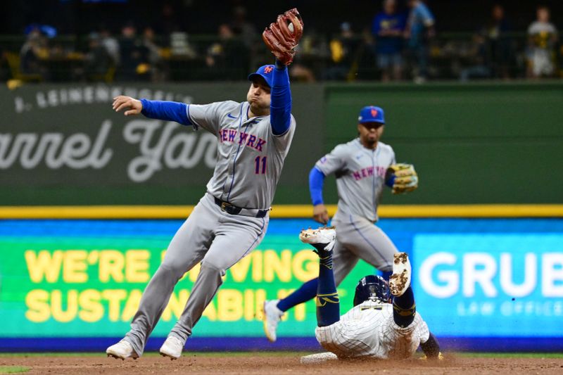 Oct 3, 2024; Milwaukee, Wisconsin, USA; Milwaukee Brewers outfielder Jackson Chourio (11) steals second base against New York Mets second baseman Jose Iglesias (11) in the fifth inning during game three of the Wildcard round for the 2024 MLB Playoffs at American Family Field. Mandatory Credit: Benny Sieu-Imagn Images