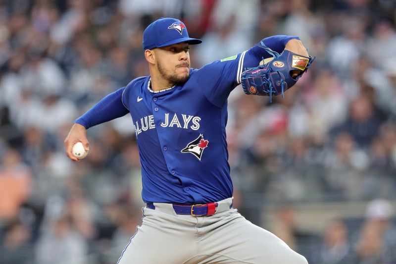 Apr 25, 2025; Bronx, New York, USA; Toronto Blue Jays starting pitcher Jose Berrios (17) pitches against the New York Yankees during the first inning at Yankee Stadium. Mandatory Credit: Brad Penner-Imagn Images