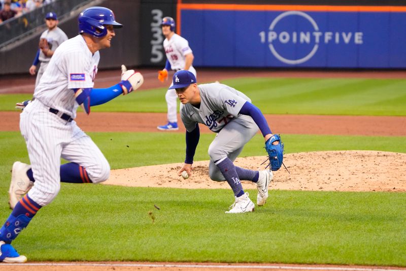 Jul 16, 2023; New York City, New York, USA; Los Angeles Dodgers pitcher Bobby Miller (70) fields a ball hit by New York Mets center fielder Brandon Nimmo (9) during the fifth inning at Citi Field. Mandatory Credit: Gregory Fisher-USA TODAY Sports