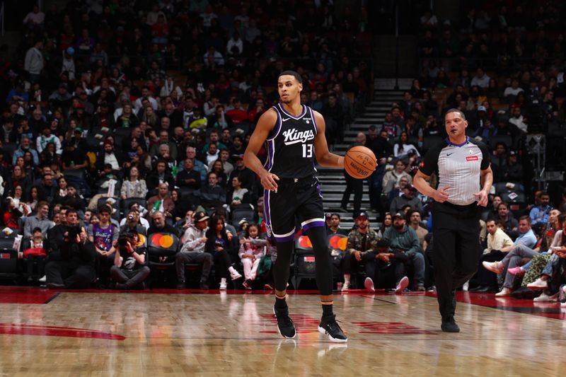 TORONTO, CANADA - MARCH 20: Keegan Murray #13 of the Sacramento Kings dribbles the ball during the game against the Toronto Raptors on March 20, 2024 at the Scotiabank Arena in Toronto, Ontario, Canada.  NOTE TO USER: User expressly acknowledges and agrees that, by downloading and or using this Photograph, user is consenting to the terms and conditions of the Getty Images License Agreement.  Mandatory Copyright Notice: Copyright 2024 NBAE (Photo by Vaughn Ridley/NBAE via Getty Images)