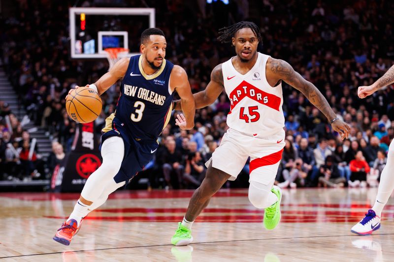 TORONTO, CANADA - JANUARY 27: CJ McCollum #3 of the New Orleans Pelicans dribbles against Davion Mitchell #45 of the Toronto Raptors during second half of their NBA game at Scotiabank Arena on January 27, 2025 in Toronto, Canada. NOTE TO USER: User expressly acknowledges and agrees that, by downloading and or using this photograph, User is consenting to the terms and conditions of the Getty Images License Agreement. (Photo by Cole Burston/Getty Images)