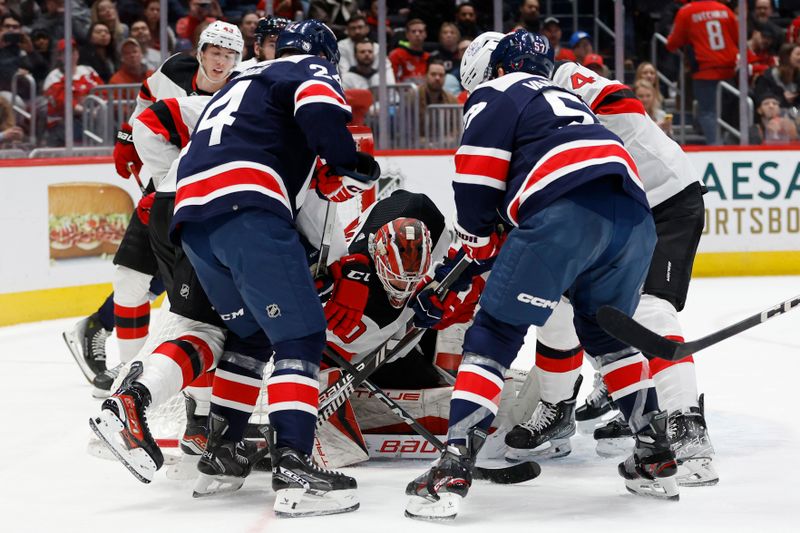 Feb 20, 2024; Washington, District of Columbia, USA; New Jersey Devils goaltender Nico Daws (50) covers the puck in front of a scrum of players against the Washington Capitals in the second period at Capital One Arena. Mandatory Credit: Geoff Burke-USA TODAY Sports