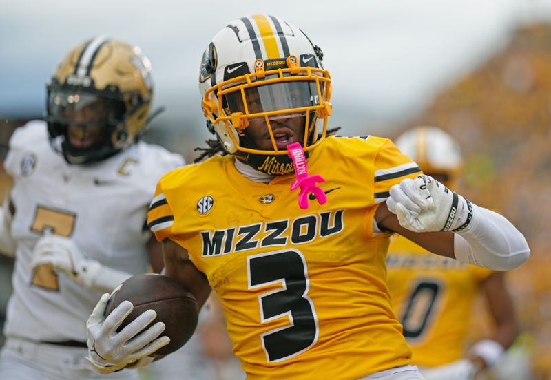 Sep 21, 2024; Columbia, Missouri, USA; Missouri Tigers wide receiver Luther Burden III (3) scores a touchdown against Vanderbilt Commodores safety Marlen Sewell (7) during the first half at Faurot Field at Memorial Stadium. Mandatory Credit: Jay Biggerstaff-Imagn Images