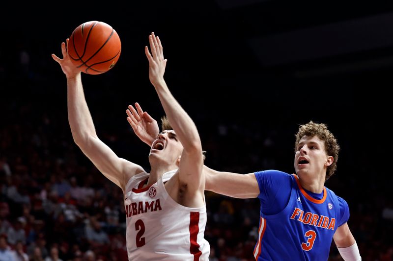 Feb 21, 2024; Tuscaloosa, Alabama, USA; Alabama Crimson Tide forward Grant Nelson (2) is fouled by Florida Gators center Micah Handlogten (3) during the first half at Coleman Coliseum. Mandatory Credit: Butch Dill-USA TODAY Sports