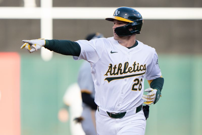 Apr 29, 2024; Oakland, California, USA;  Oakland Athletics outfielder Tyler Nevin (26) points to the bullpen after hitting a solo home run during the first inning against the Pittsburgh Pirates at Oakland-Alameda County Coliseum. Mandatory Credit: Stan Szeto-USA TODAY Sports