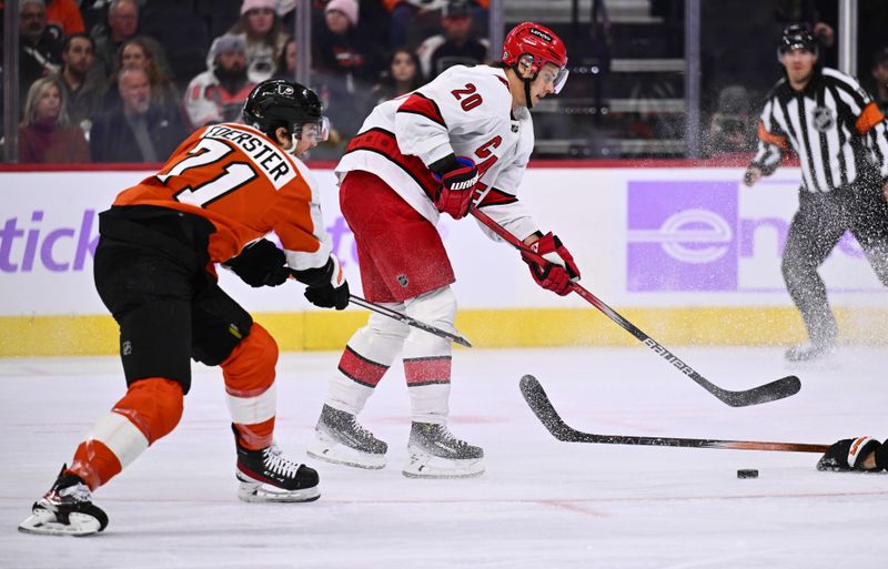 Nov 28, 2023; Philadelphia, Pennsylvania, USA; Carolina Hurricanes center Sebastian Aho (20) reaches for the puck against Philadelphia Flyers right wing Tyson Foerster (71) in the first period at Wells Fargo Center. Mandatory Credit: Kyle Ross-USA TODAY Sports