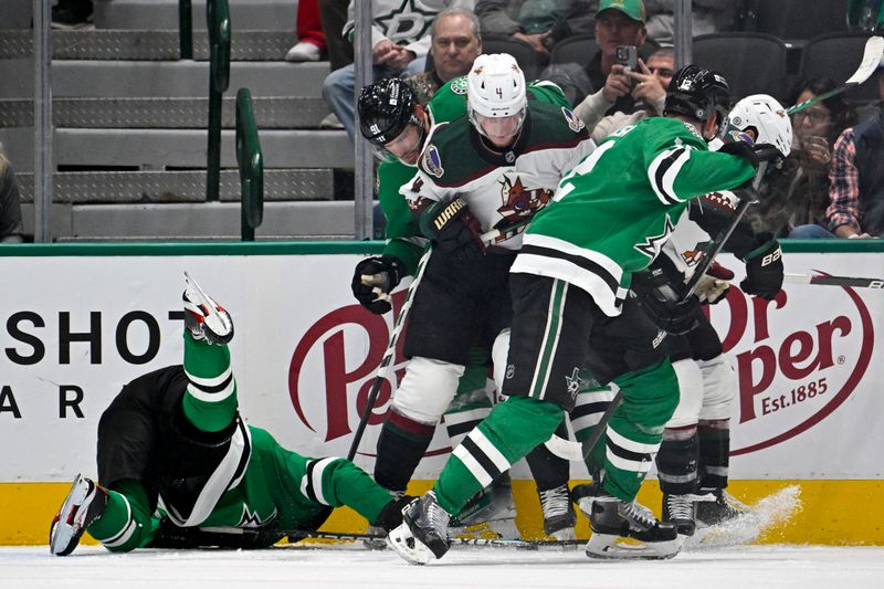 Nov 14, 2023; Dallas, Texas, USA; Dallas Stars center Tyler Seguin (91) and Arizona Coyotes defenseman Juuso Valimaki (4) battle for control of the puck during the first period at the American Airlines Center. Mandatory Credit: Jerome Miron-USA TODAY Sports