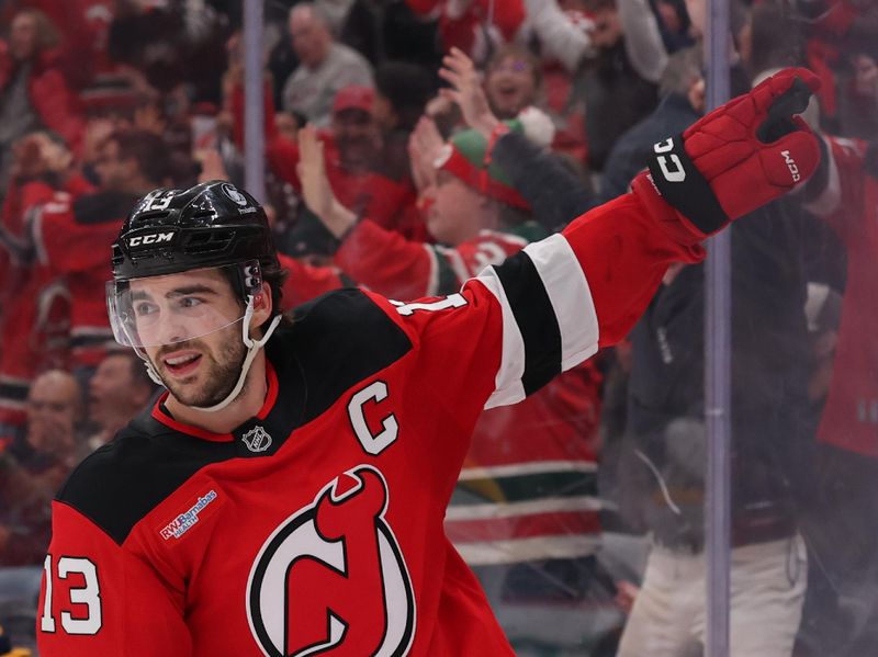 Jan 29, 2026; Newark, New Jersey, USA; New Jersey Devils center Nico Hischier (13) celebrates his overtime game winning goal against the Nashville Predators at Prudential Center. Mandatory Credit: Ed Mulholland-Imagn Images