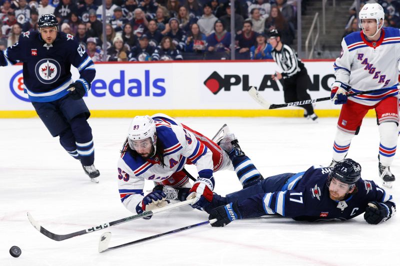 Oct 30, 2023; Winnipeg, Manitoba, CAN; New York Rangers center Mika Zibanejad (93) and Winnipeg Jets center Adam Lowry (17) stretch for the puck in the second period at Canada Life Centre. Mandatory Credit: James Carey Lauder-USA TODAY Sports