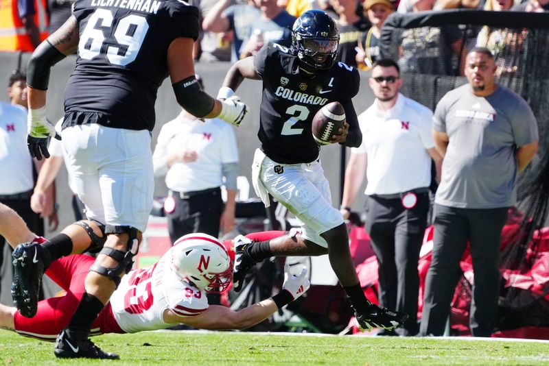 Sep 9, 2023; Boulder, Colorado, USA; Colorado Buffaloes quarterback Shedeur Sanders (2) evades Nebraska Cornhuskers linebacker Javin Wright (33) in the second quarter at Folsom Field. Mandatory Credit: Ron Chenoy-USA TODAY Sports