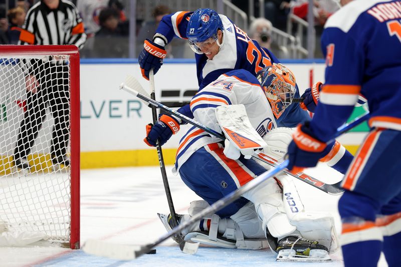 Dec 19, 2023; Elmont, New York, USA; New York Islanders left wing Anders Lee (27) scores a power play goal against Edmonton Oilers goaltender Stuart Skinner (74) during the second period at UBS Arena. Mandatory Credit: Brad Penner-USA TODAY Sports