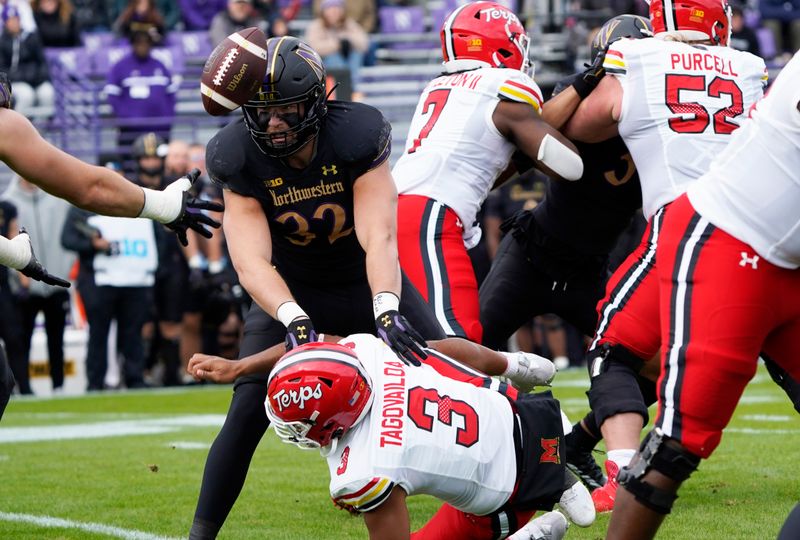 Oct 28, 2023; Evanston, Illinois, USA; Northwestern Wildcats linebacker Bryce Gallagher (32) forces a fumble by Maryland Terrapins quarterback Taulia Tagovailoa (3) during the first half at Ryan Field. Mandatory Credit: David Banks-USA TODAY Sports