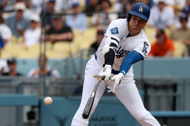 Sep 21, 2025; Los Angeles, California, USA;  Los Angeles Dodgers designated hitter Shohei Ohtani (17) hits a broken bat single during the sixth inning against the San Francisco Giants at Dodger Stadium. Mandatory Credit: Kiyoshi Mio-Imagn Images