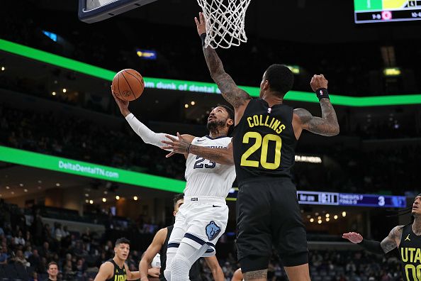 MEMPHIS, TENNESSEE - NOVEMBER 29: Derrick Rose #23 of the Memphis Grizzlies goes to the basket against John Collins #20 of the Utah Jazz during the first half at FedExForum on November 29, 2023 in Memphis, Tennessee. NOTE TO USER: User expressly acknowledges and agrees that, by downloading and or using this photograph, User is consenting to the terms and conditions of the Getty Images License Agreement.  (Photo by Justin Ford/Getty Images)