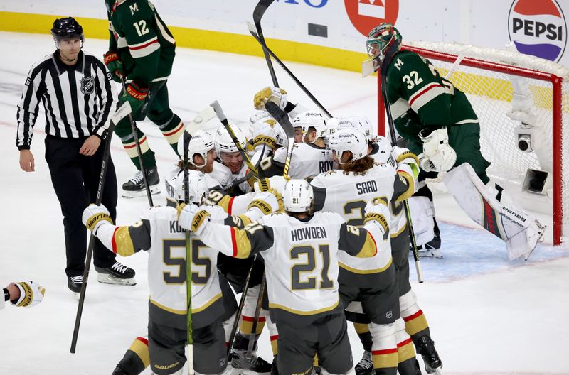 Apr 26, 2025; Saint Paul, Minnesota, USA; Vegas Golden Knights center Ivan Barbashev (49) celebrates with teammates after he puts the puck past Minnesota Wild goaltender Filip Gustavsson (32) during 1st OT in game four of the first round of the 2025 Stanley Cup Playoffs at Xcel Energy Center. Vegas Golden Knights win 4-3. Mandatory Credit: Bruce Fedyck-Imagn Images