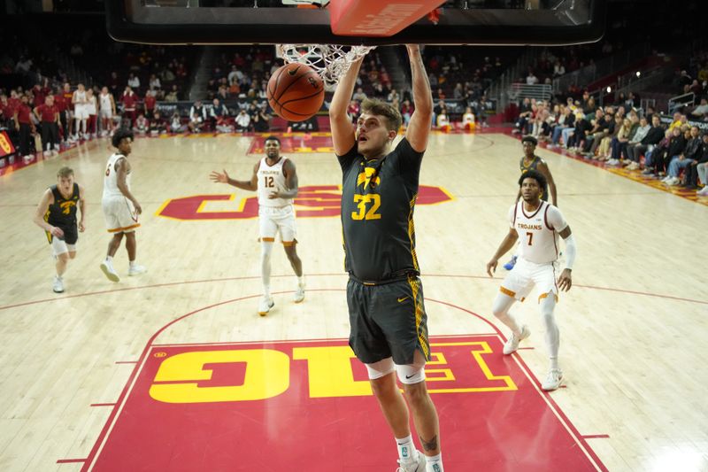 Jan 14, 2025; Los Angeles, California, USA; Iowa Hawkeyes forward Owen Freeman (32) dunks the ball against the Southern California Trojans in the second half at the Galen Center. Mandatory Credit: Kirby Lee-Imagn Images