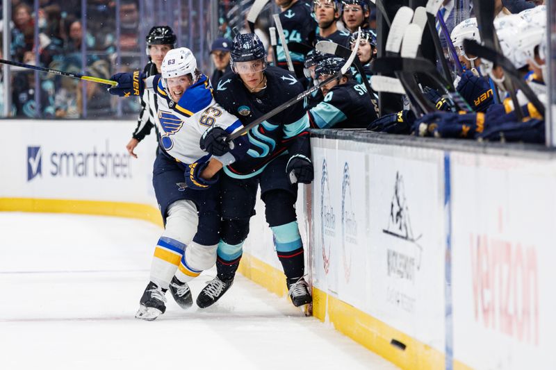 Oct 8, 2024; Seattle, Washington, USA; St. Louis Blues left wing Jake Neighbours (63) collides into Seattle Kraken defenseman Ryker Evans (41) during the first period at Climate Pledge Arena. Mandatory Credit: Caean Couto-Imagn Images