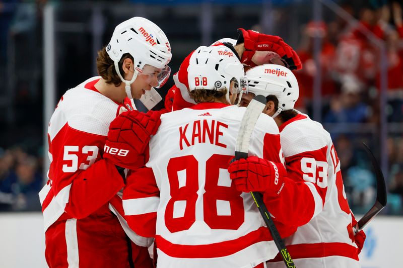 Feb 19, 2024; Seattle, Washington, USA; Detroit Red Wings defenseman Moritz Seider (53, left) celebrates with right wing Patrick Kane (88) and right wing Alex DeBrincat (93) after scoring a goal against the Seattle Kraken during the first period at Climate Pledge Arena. Mandatory Credit: Joe Nicholson-USA TODAY Sports