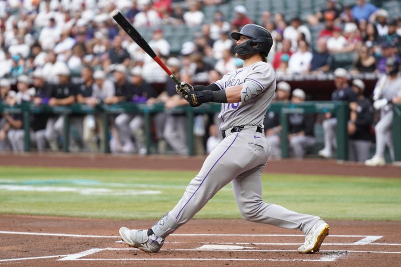 May 17, 2025; Phoenix, Arizona, USA;  Colorado Rockies catcher Hunter Goodman (15) hits a home run against the Arizona Diamondbacks in the first inning at Chase Field. Mandatory Credit: Jacob Reiner-Imagn Images