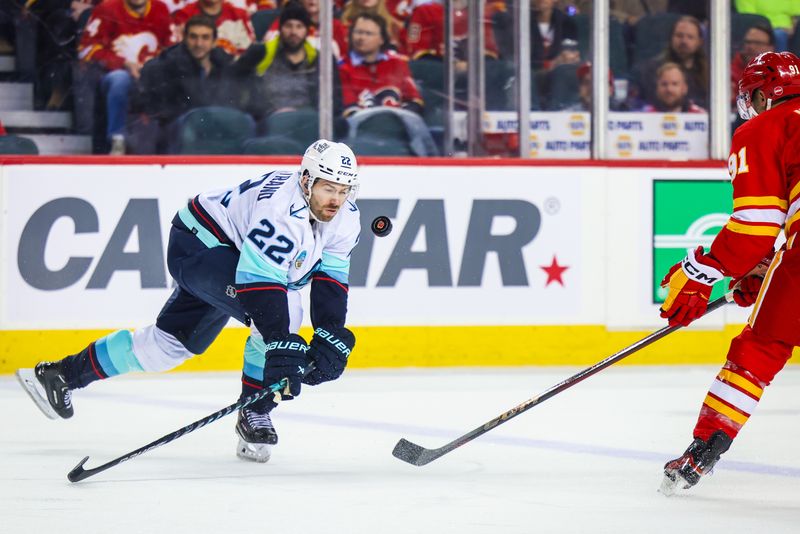 Mar 4, 2024; Calgary, Alberta, CAN; Seattle Kraken right wing Oliver Bjorkstrand (22) and Calgary Flames center Nazem Kadri (91) battles for the puck during the first period at Scotiabank Saddledome. Mandatory Credit: Sergei Belski-USA TODAY Sports