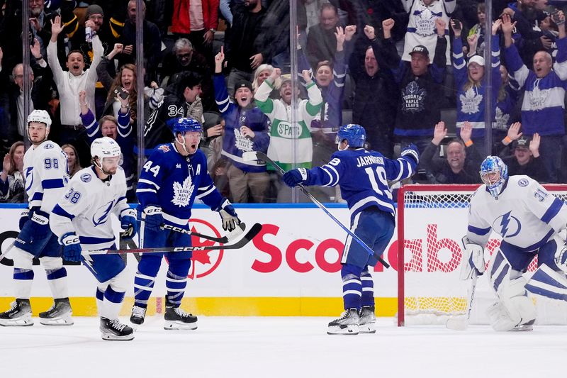 Nov 6, 2023; Toronto, Ontario, CAN; Toronto Maple Leafs defenseman Morgan Rielly (44) reacts to the winning goal by forward Calle Jarnkrok (19) against the Tampa Bay Lightning goaltender Jonas Johansson (31) during overtime at Scotiabank Arena. Mandatory Credit: John E. Sokolowski-USA TODAY Sports