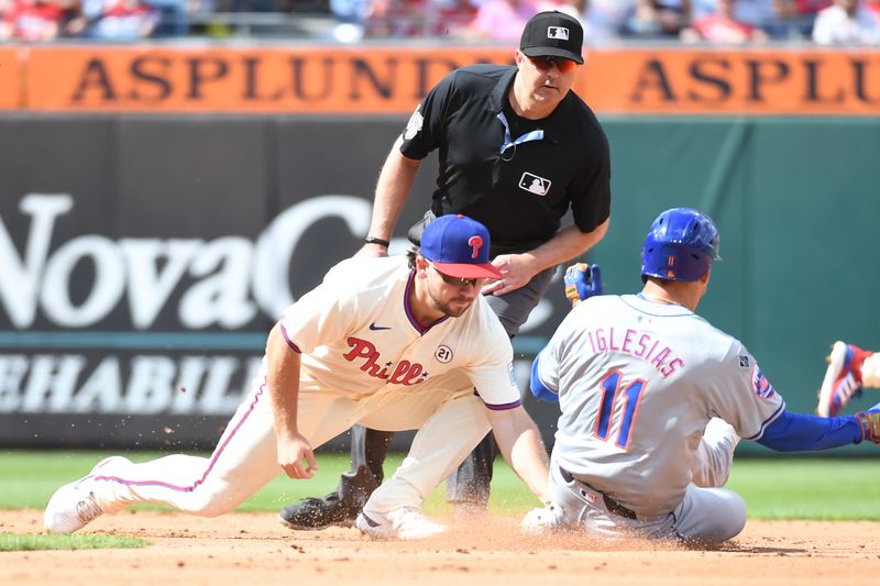 Sep 15, 2024; Philadelphia, Pennsylvania, USA; Philadelphia Phillies second base Buddy Kennedy (19) tags out New York Mets second base Jose Iglesias (11) trying to steal second base during the fifth inning at Citizens Bank Park. Mandatory Credit: Eric Hartline-Imagn Images