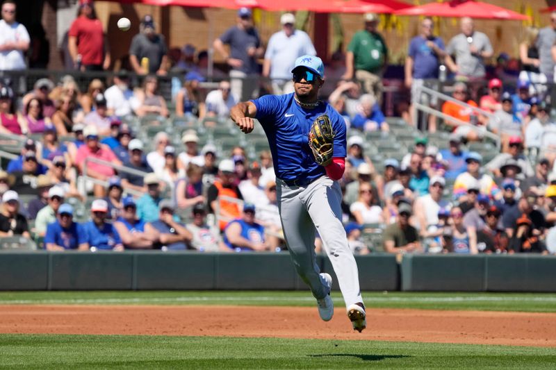 Mar 21, 2024; Salt River Pima-Maricopa, Arizona, USA; Chicago Cubs third baseman Christopher Morel (5) makes the off balance throw against the Colorado Rockies in the first inning at Salt River Fields at Talking Stick. Mandatory Credit: Rick Scuteri-USA TODAY Sports