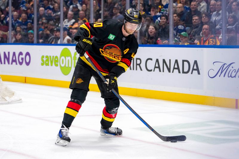 Mar 19, 2024; Vancouver, British Columbia, CAN; Vancouver Canucks forward Elias Pettersson (40) handles the puck against the Buffalo Sabres in the first period at Rogers Arena. Mandatory Credit: Bob Frid-USA TODAY Sports