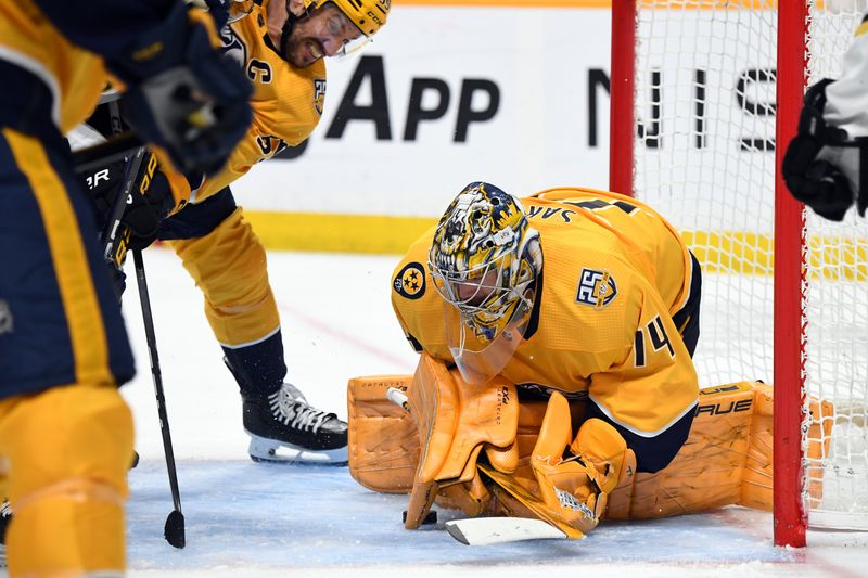 Apr 2, 2024; Nashville, Tennessee, USA; Nashville Predators goaltender Juuse Saros (74) loses the puck in the crease after a save during the second period against the Boston Bruins at Bridgestone Arena. Mandatory Credit: Christopher Hanewinckel-USA TODAY Sports