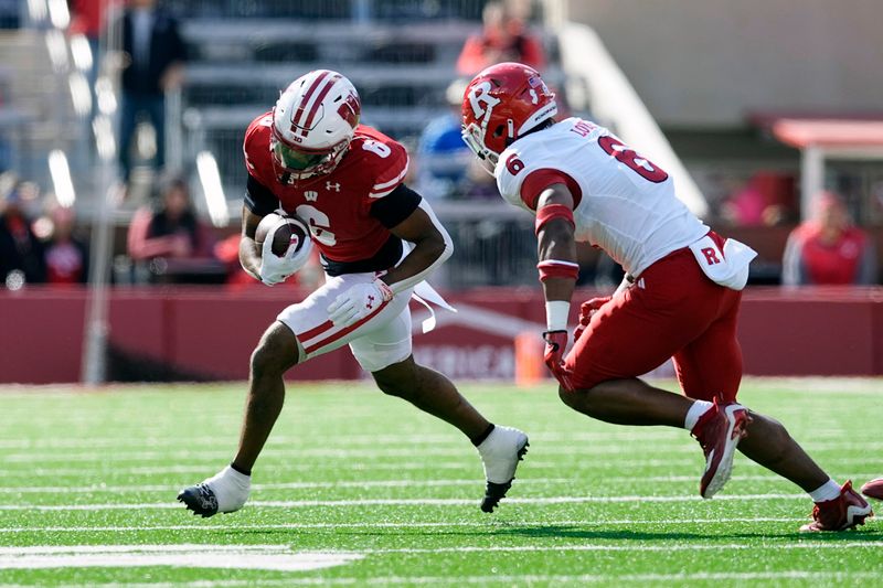Oct 7, 2023; Madison, Wisconsin, USA;  Wisconsin Badgers wide receiver Will Pauling (6) carries the football as Rutgers Scarlet Knights defensive back Shaquan Loyal (6) defends during the first quarter at Camp Randall Stadium. Mandatory Credit: Jeff Hanisch-USA TODAY Sports
