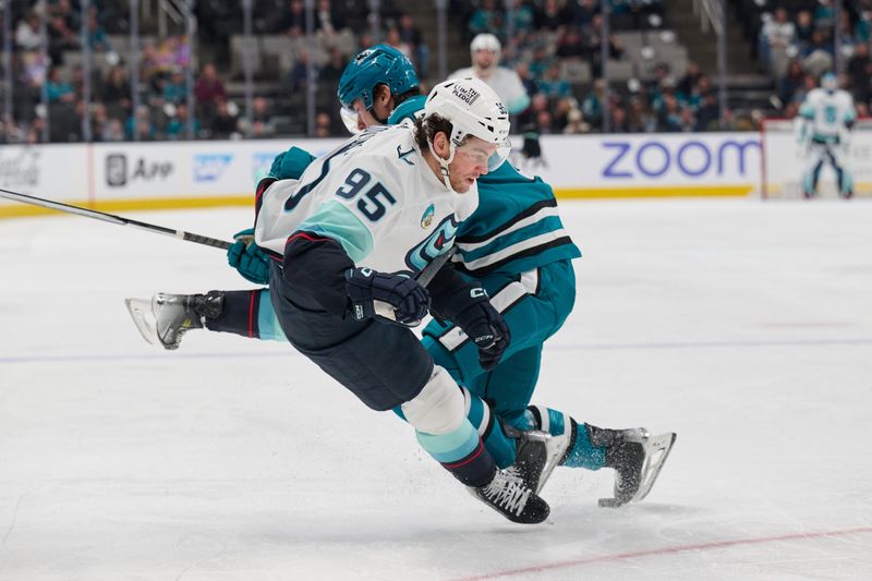 Jan 30, 2024; San Jose, California, USA; San Jose Sharks defenseman Shakir Mukhamadullin (85) trips Seattle Kraken left wing Andre Burakovsky (95) for a penalty during the first period at SAP Center at San Jose. Mandatory Credit: Robert Edwards-USA TODAY Sports