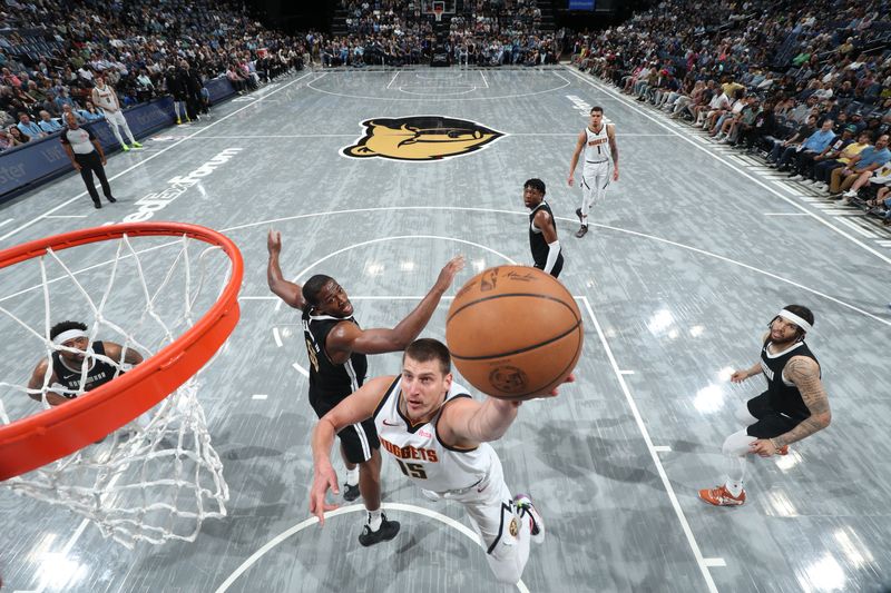 MEMPHIS, TN - APRIL 14:  Nikola Jokic #15 of the Denver Nuggets drives to the basket during the game against the Memphis Grizzlies on April 14, 2024 at FedExForum in Memphis, Tennessee. NOTE TO USER: User expressly acknowledges and agrees that, by downloading and or using this photograph, User is consenting to the terms and conditions of the Getty Images License Agreement. Mandatory Copyright Notice: Copyright 2024 NBAE (Photo by Joe Murphy/NBAE via Getty Images)