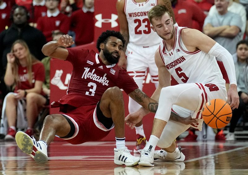 Jan 6, 2024; Madison, Wisconsin, USA; Nebraska guard Brice Williams (3) is fouled by Wisconsin forward Tyler Wahl (5) during the second half of their game at Kohl Center. Mandatory Credit: Mark Hoffman-USA TODAY Sports