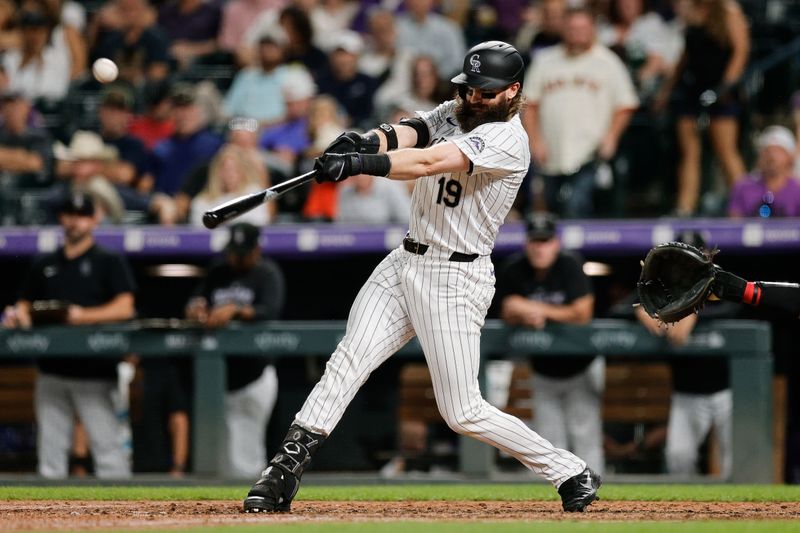 Aug 27, 2024; Denver, Colorado, USA; Colorado Rockies designated hitter Charlie Blackmon (19) hits a single in the sixth inning against the Miami Marlins at Coors Field. Mandatory Credit: Isaiah J. Downing-USA TODAY Sports